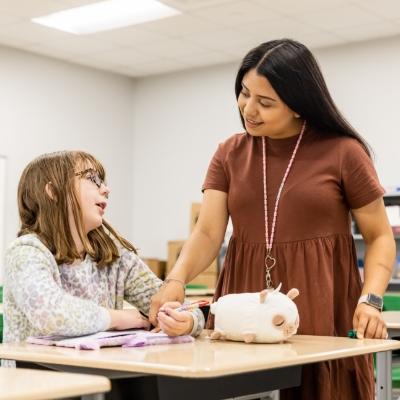 Woman and child in a classroom setting.